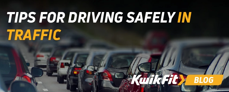 Cars lined up stuck in traffic.